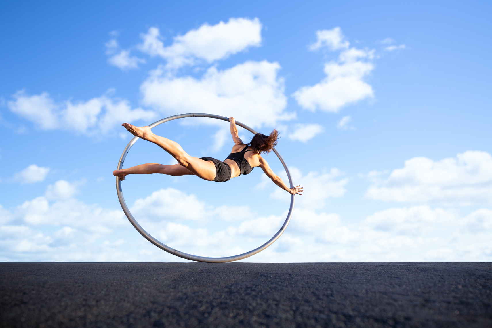 Circus performer on a Cyr wheel caputed by fitness advertising photographer Robert Houser