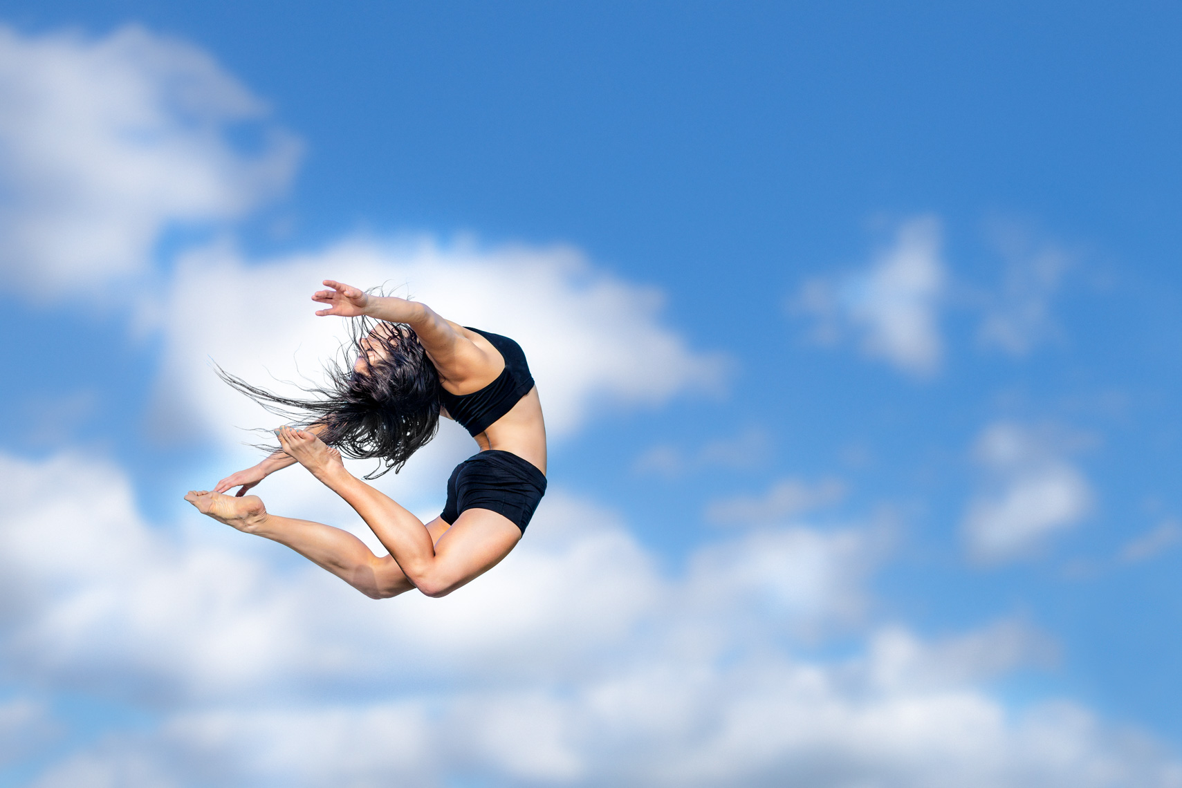 Hip hop dancer with clouds and sky  - a study of movement by San Francisco photographer  Robert Houser.